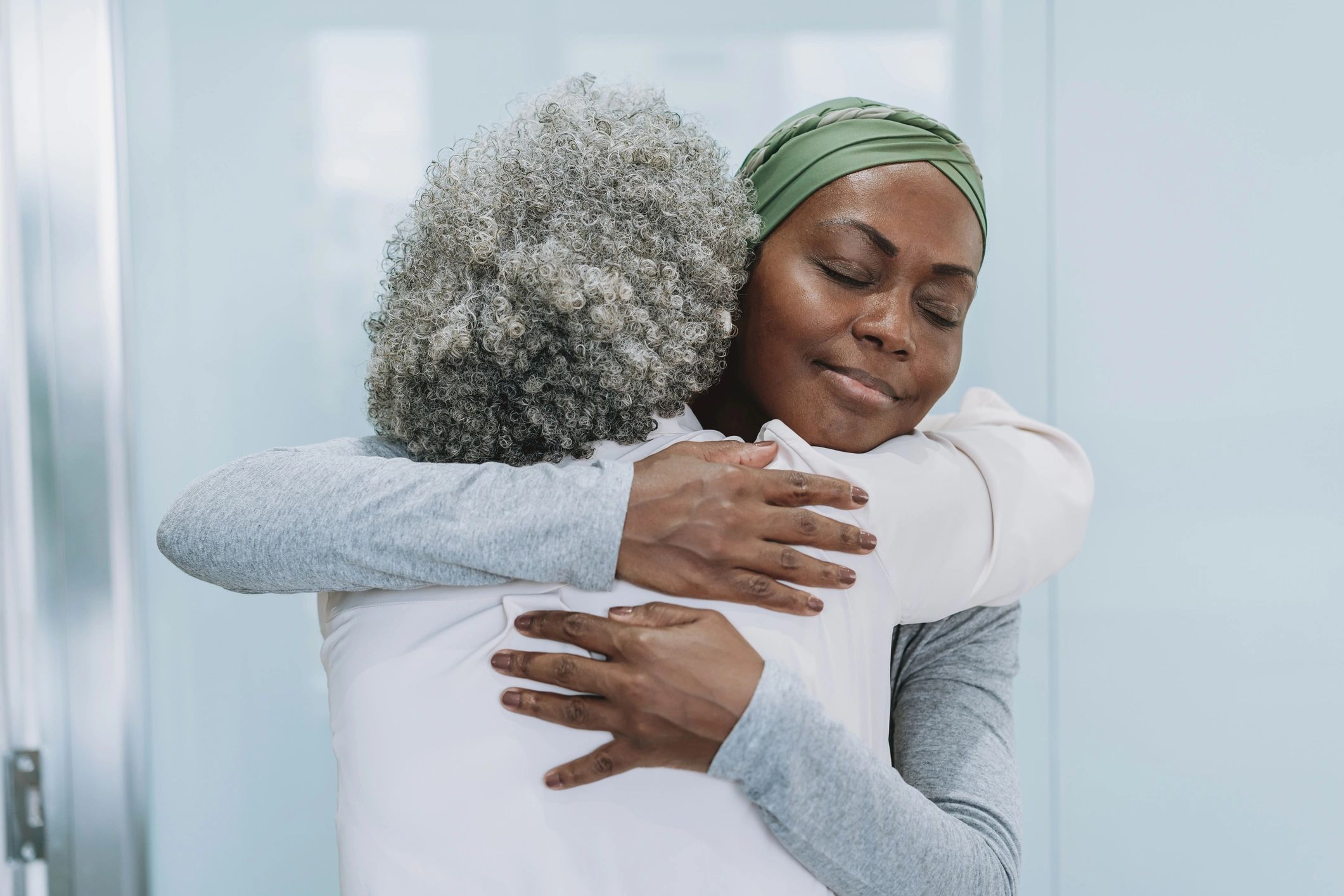 Two women embracing in a moment of support and healing